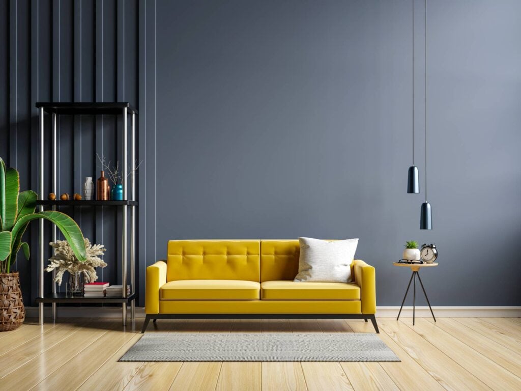 yellow sofa and a wooden table in living room interior with plant,dark blue wall.