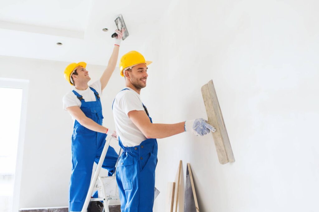 group of builders with tools indoors